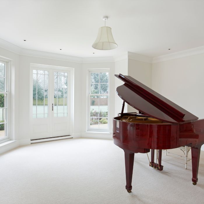 Brown Baby Grand Piano in white room