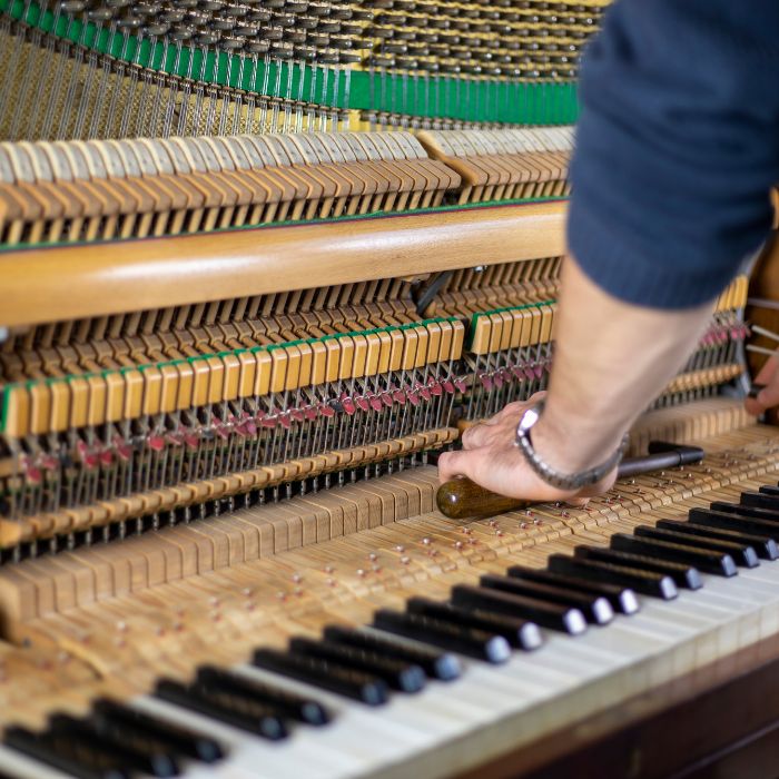 A Piano Tuner Working
