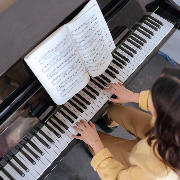 Playing piano using sheet music